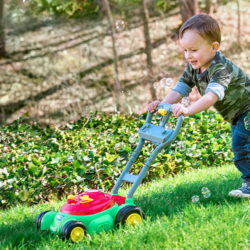 Toddler with a Bubble-N-Go Mower on the grass